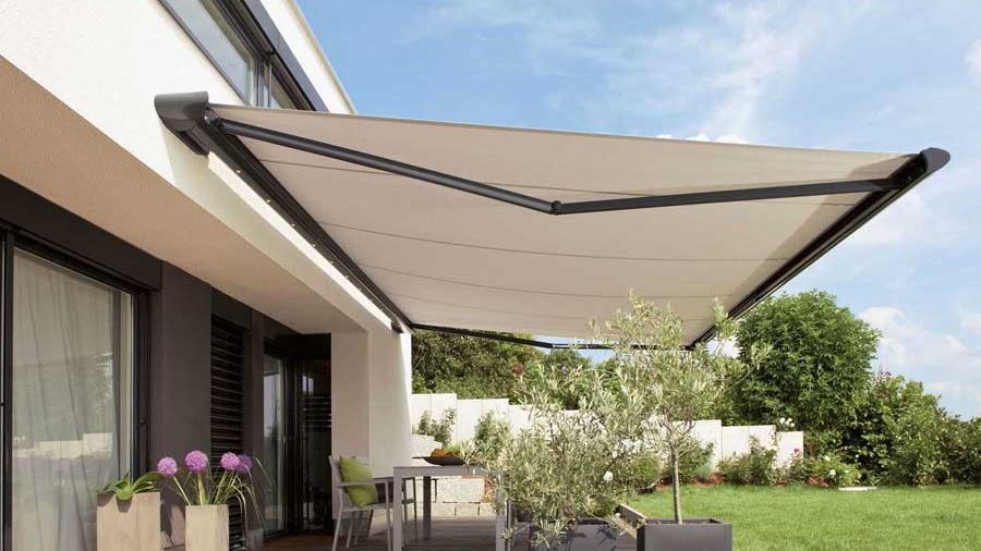Toldo de brazos articulados extendido sobre la terraza de una vivienda